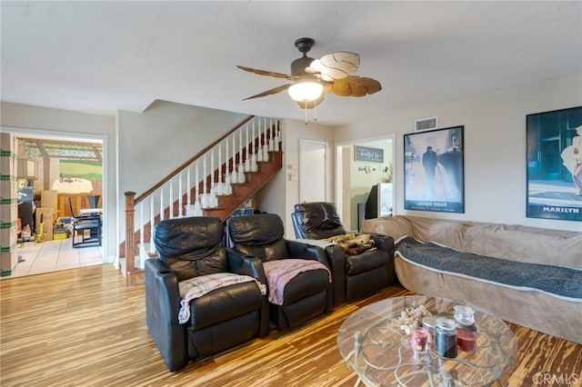 24851 Stem Ave, Lake Forest, CA 92630 - living room with stairs, light wood-style flooring, and ceiling fan