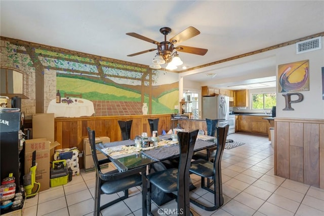 24851 Stem Ave, Lake Forest, CA 92630 - dining space with a ceiling fan, light tile patterned flooring, and wooden walls