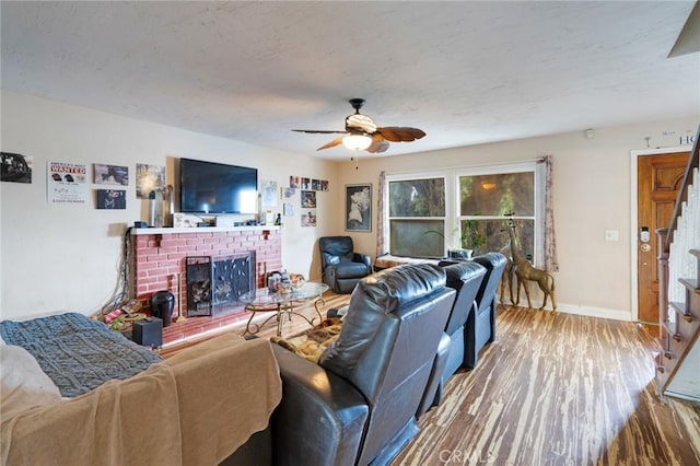 24851 Stem Ave, Lake Forest, CA 92630 - living room with a brick fireplace, ceiling fan, wood finished floors, stairs, and baseboards