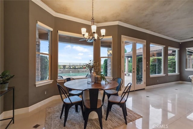 dining area with light tile patterned floors, baseboards, an inviting chandelier, ornamental molding, and french doors