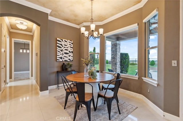 dining area with baseboards, light tile patterned floors, a notable chandelier, and arched walkways