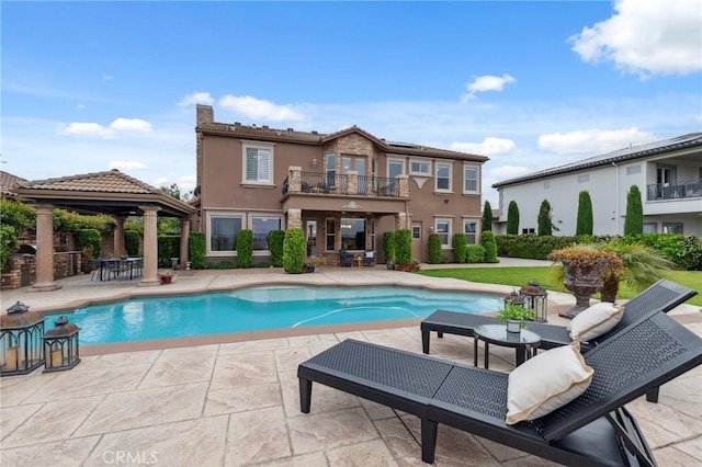 pool with a patio and a gazebo