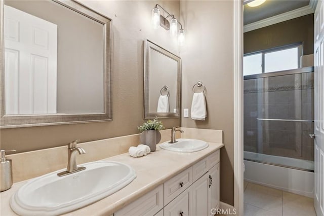 full bathroom with double vanity, crown molding, tile patterned flooring, and a sink