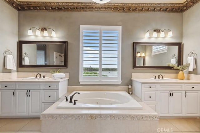 bathroom featuring a jetted tub, two vanities, tile patterned flooring, and a sink