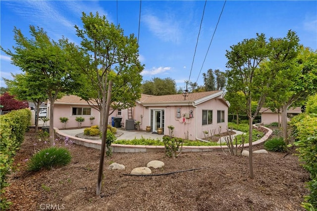 back of house with a patio area, stucco siding, and cooling unit