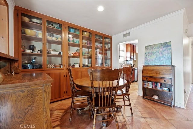 dining room with crown molding, recessed lighting, light tile patterned flooring, and visible vents