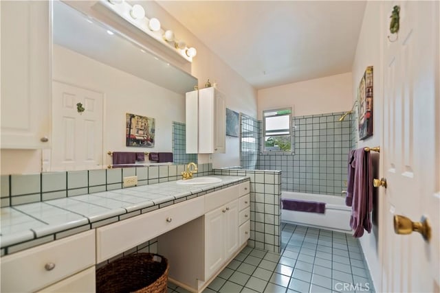 bathroom with tile patterned flooring, shower / bathing tub combination, and vanity