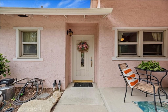 entrance to property with stucco siding
