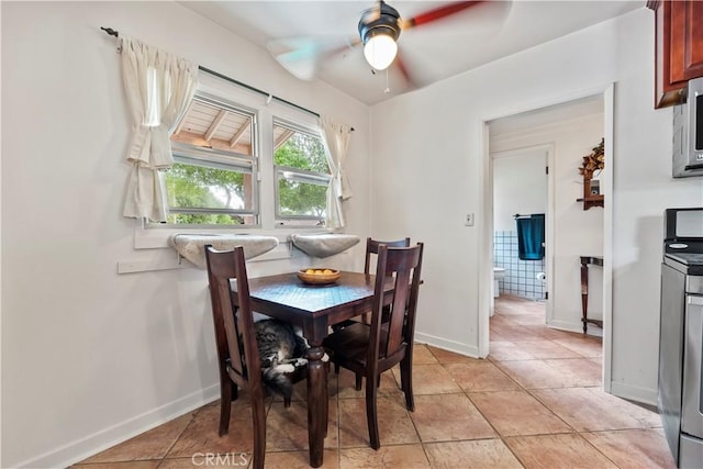 dining area featuring baseboards and ceiling fan