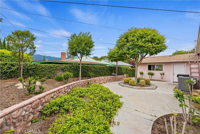view of yard featuring a patio and central AC unit