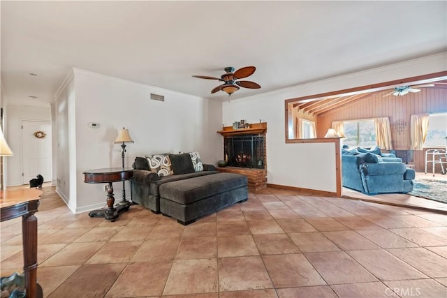 living area with crown molding, baseboards, a ceiling fan, and visible vents