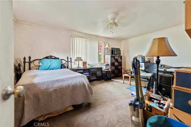 bedroom featuring crown molding, carpet, and ceiling fan