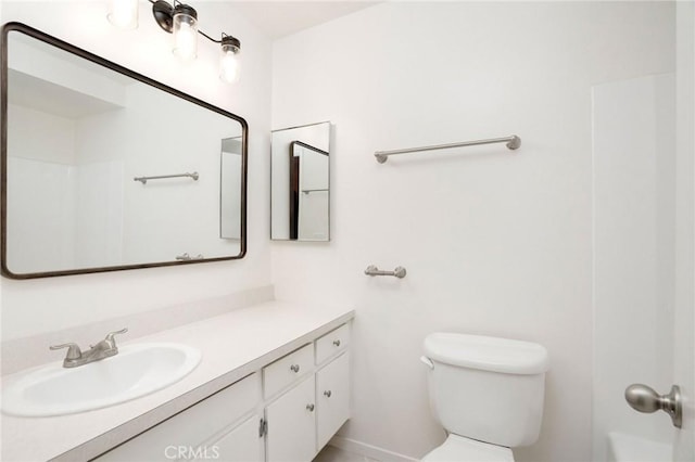 bathroom featuring toilet and vanity