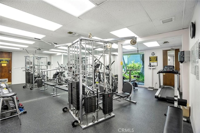 exercise room featuring visible vents and a paneled ceiling