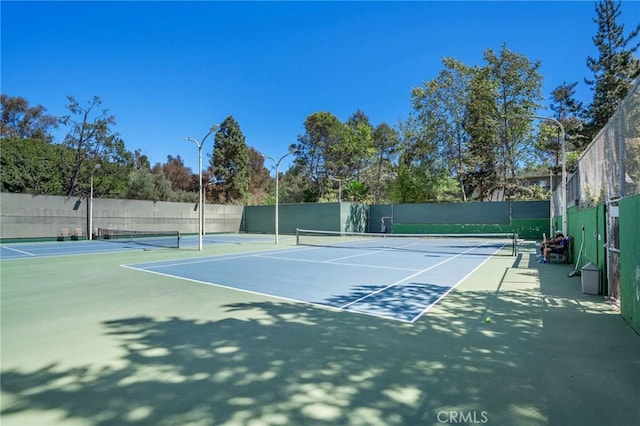 view of sport court featuring fence and community basketball court
