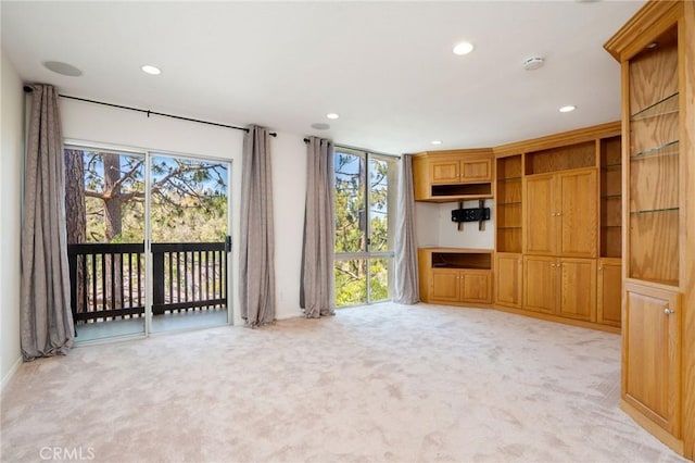 unfurnished living room featuring light colored carpet, recessed lighting, and plenty of natural light