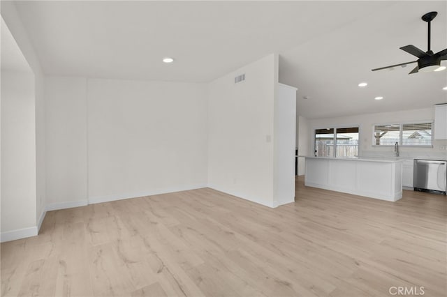unfurnished living room featuring baseboards, recessed lighting, ceiling fan, and light wood-style floors