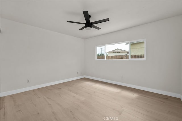 unfurnished room with light wood finished floors, ceiling fan, and baseboards