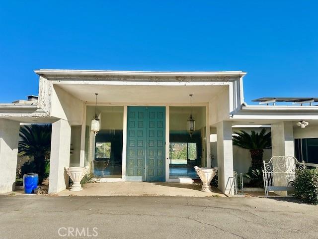 entrance to property featuring stucco siding