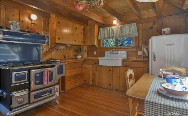230 Fremont Rd, Lake Arrowhead, CA 92352 - kitchen with a sink, refrigerator, wood finished floors, under cabinet range hood, and beamed ceiling