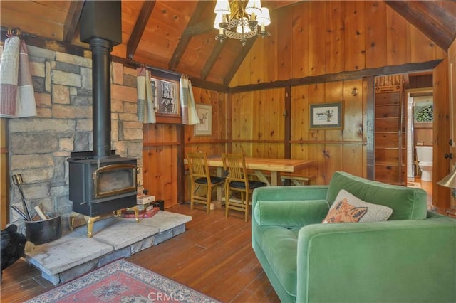 230 Fremont Rd, Lake Arrowhead, CA 92352 - living area featuring hardwood / wood-style floors, wood walls, a wood stove, beamed ceiling, and wooden ceiling
