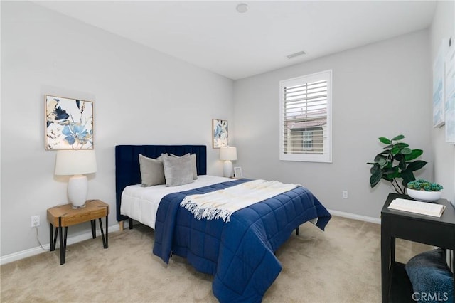 bedroom with baseboards, visible vents, and light colored carpet