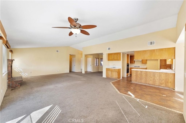 15631 Via Cartagena St, Hesperia, CA 92345 - unfurnished living room with lofted ceiling, a brick fireplace, visible vents, light carpet, and a ceiling fan