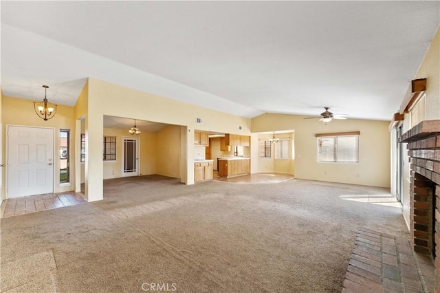 15631 Via Cartagena St, Hesperia, CA 92345 - unfurnished living room with lofted ceiling, baseboards, light carpet, a brick fireplace, and ceiling fan with notable chandelier