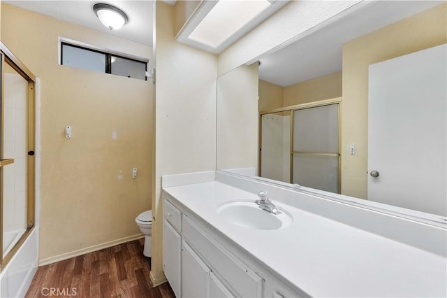 15631 Via Cartagena St, Hesperia, CA 92345 - bathroom featuring wood finished floors, toilet, vanity, and baseboards