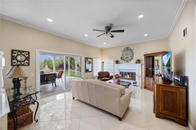 living room featuring a high end fireplace, ceiling fan, ornamental molding, and visible vents