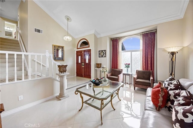 foyer entrance with visible vents, crown molding, baseboards, stairway, and light tile patterned floors