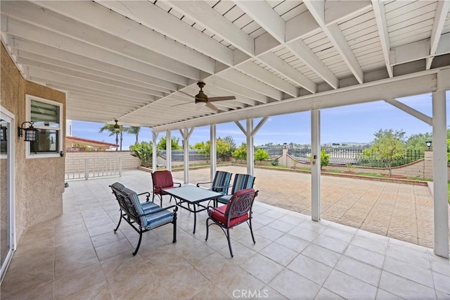 view of patio / terrace with fence and a ceiling fan
