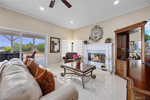 living room with baseboards, recessed lighting, a high end fireplace, a ceiling fan, and light tile patterned floors