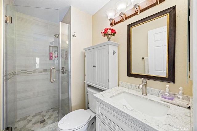 full bath featuring vanity, a stall shower, and toilet