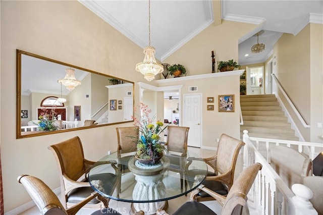 dining room featuring high vaulted ceiling, a chandelier, and stairway