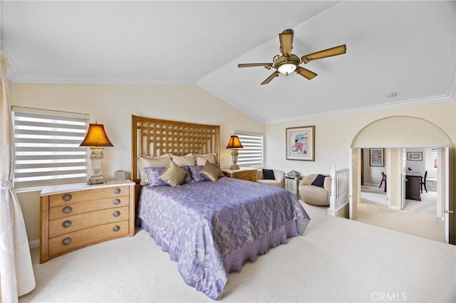 bedroom featuring ceiling fan, light colored carpet, ornamental molding, and vaulted ceiling
