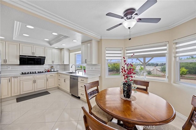 kitchen with crown molding, light countertops, backsplash, and dishwasher
