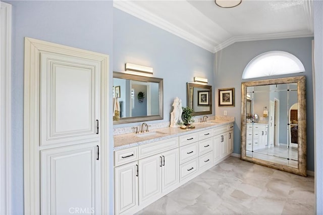 full bath featuring crown molding, a sink, vaulted ceiling, and double vanity