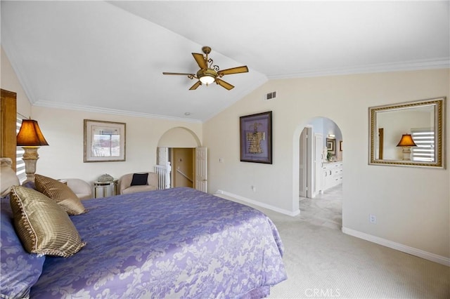 carpeted bedroom with visible vents, crown molding, arched walkways, baseboards, and lofted ceiling