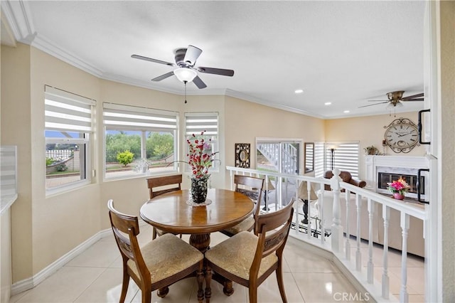dining room with light tile patterned floors, ceiling fan, and a wealth of natural light