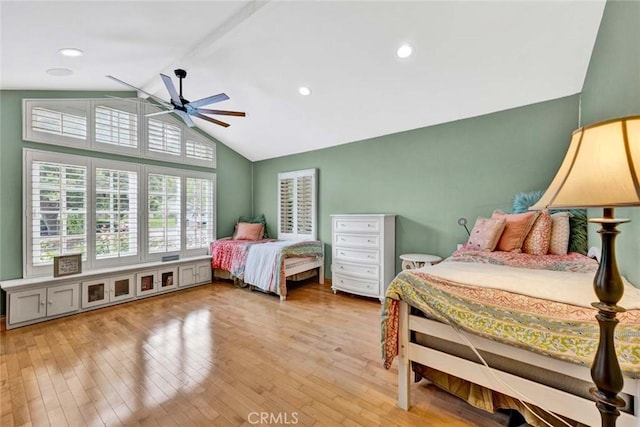 bedroom featuring ceiling fan, lofted ceiling with beams, and light wood finished floors