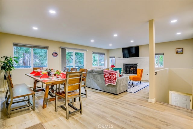 26131 Lake Forest Dr, Twin Peaks, CA 92391 - dining area featuring healthy amount of natural light, a fireplace, light wood-type flooring, recessed lighting, and baseboards