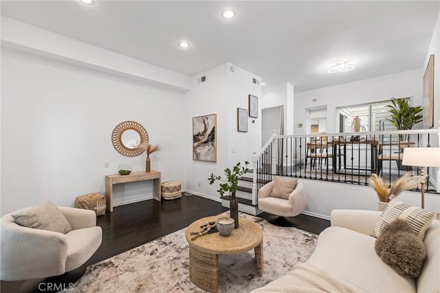 living area featuring recessed lighting, visible vents, and wood finished floors