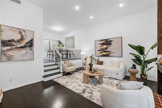 living room with recessed lighting, baseboards, and wood finished floors