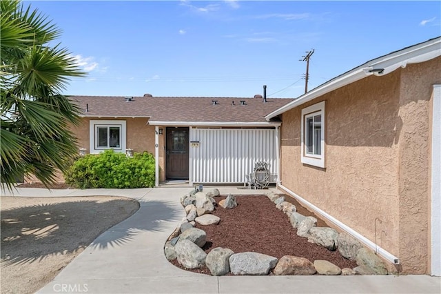 property entrance with stucco siding