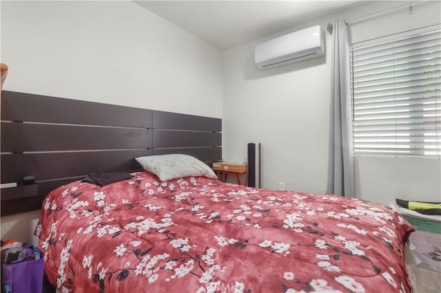 bedroom with an AC wall unit
