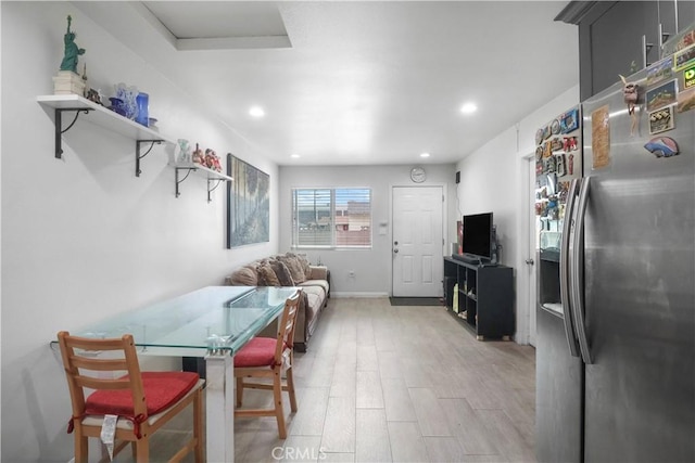 dining room with attic access, recessed lighting, light wood finished floors, and baseboards