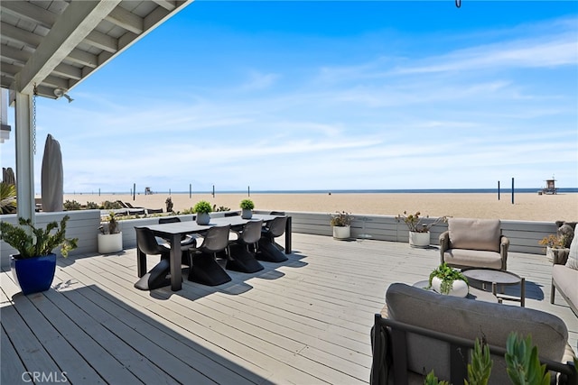 wooden deck with outdoor dining space and a water view
