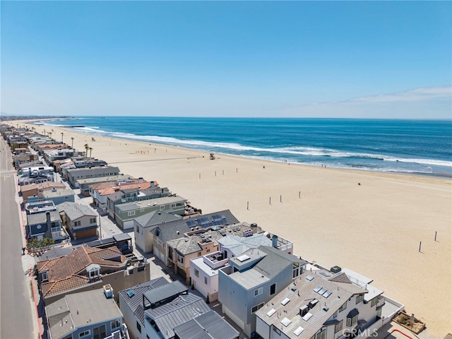 birds eye view of property featuring a view of the beach and a water view