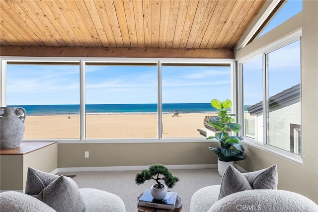 interior space with a view of the beach and a water view